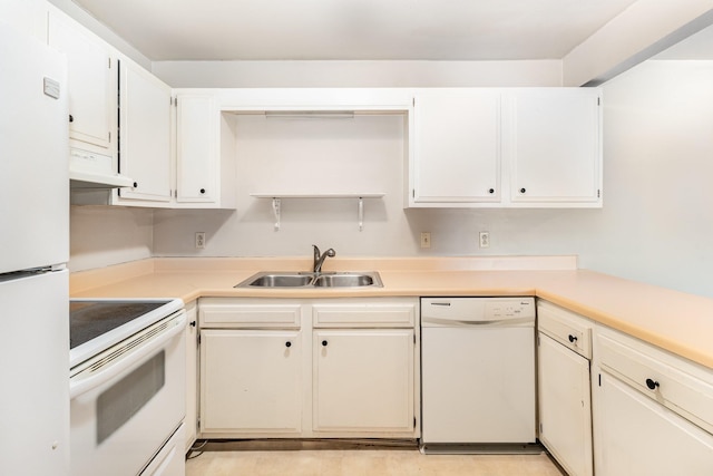 kitchen with white cabinetry, sink, and white appliances