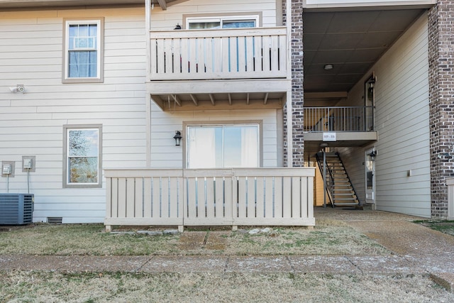 rear view of house featuring central AC unit