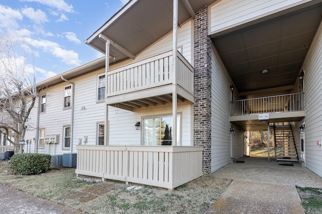 exterior space featuring central AC unit and a balcony