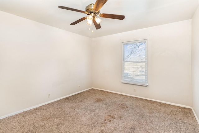 carpeted empty room featuring ceiling fan