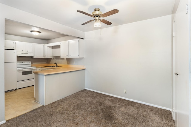 kitchen featuring sink, white appliances, white cabinets, light colored carpet, and kitchen peninsula