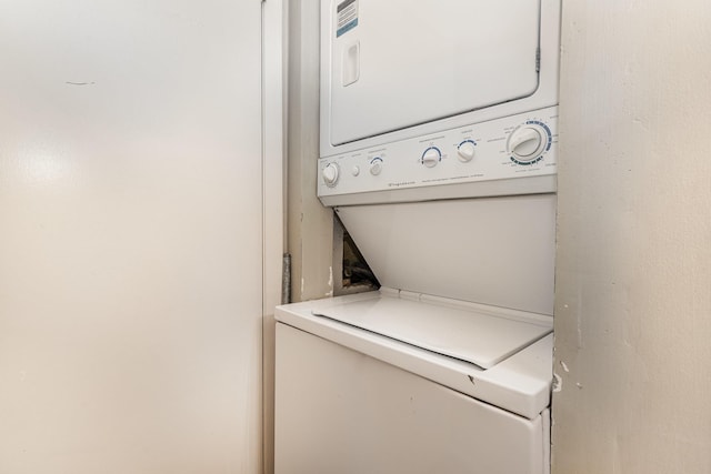 clothes washing area with stacked washer and dryer