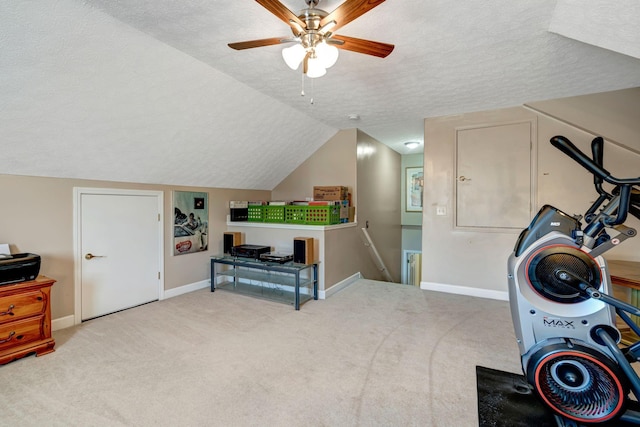 workout room with vaulted ceiling, carpet flooring, and a textured ceiling