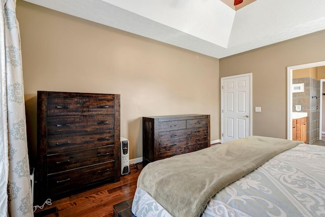 bedroom featuring dark wood-type flooring and connected bathroom