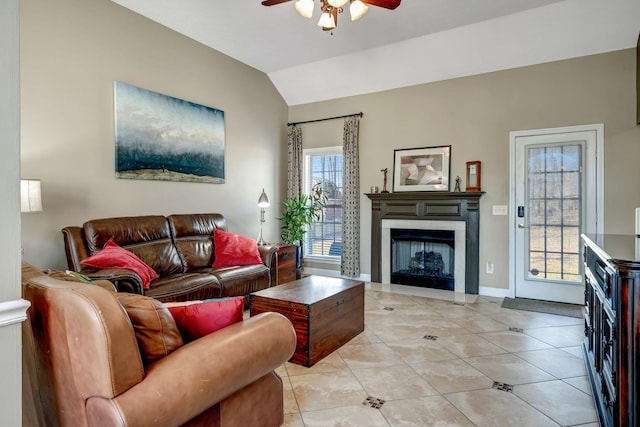 living room featuring light tile patterned floors, vaulted ceiling, and ceiling fan