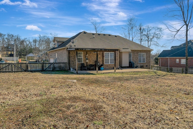 rear view of property featuring a yard and a patio