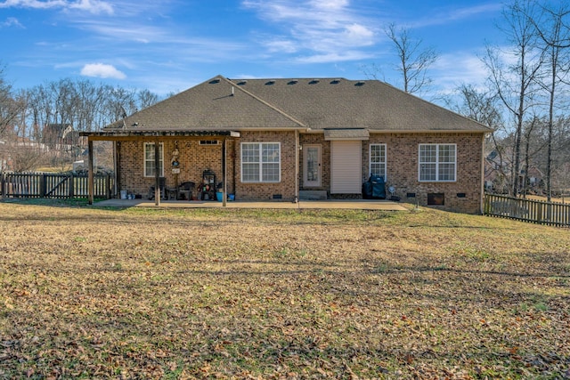 back of house featuring a lawn and a patio