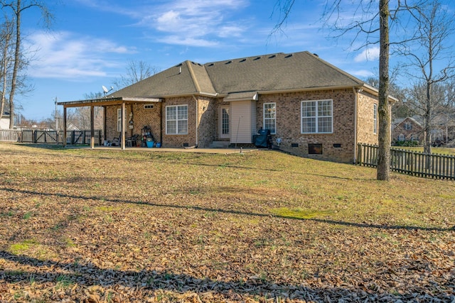 back of property with a patio and a lawn