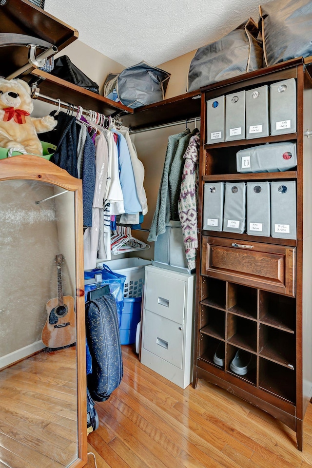 spacious closet featuring light hardwood / wood-style floors