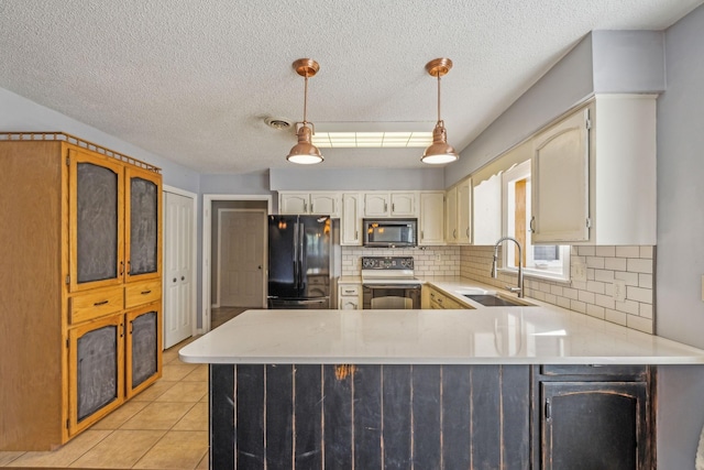 kitchen featuring pendant lighting, black appliances, sink, light tile patterned floors, and kitchen peninsula