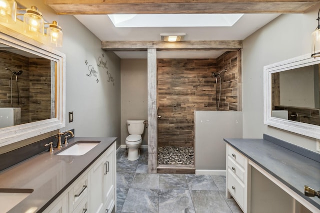 bathroom featuring vanity, beam ceiling, and a skylight