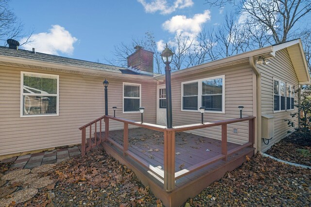 rear view of property featuring a deck