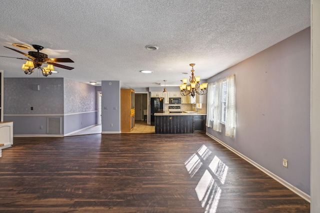 unfurnished living room featuring dark hardwood / wood-style flooring, ceiling fan with notable chandelier, and a textured ceiling