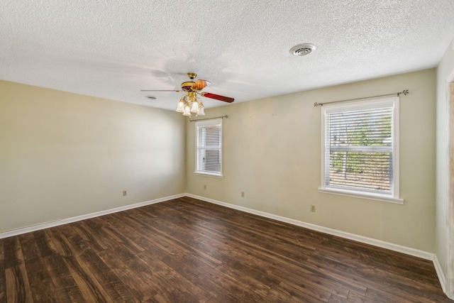 spare room featuring dark hardwood / wood-style floors, a textured ceiling, and ceiling fan