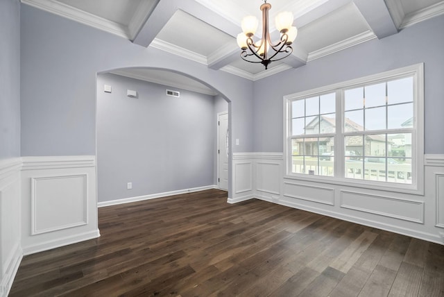 empty room with crown molding, dark hardwood / wood-style floors, coffered ceiling, beamed ceiling, and a chandelier