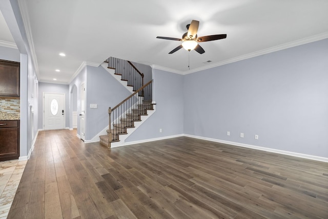 foyer featuring crown molding, ceiling fan, and dark hardwood / wood-style flooring