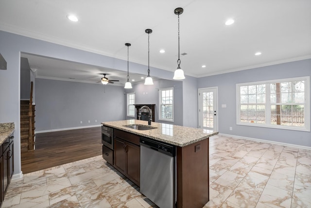 kitchen featuring sink, light stone counters, appliances with stainless steel finishes, an island with sink, and pendant lighting