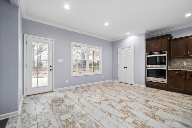 kitchen featuring tasteful backsplash, light stone countertops, dark brown cabinets, and stainless steel double oven