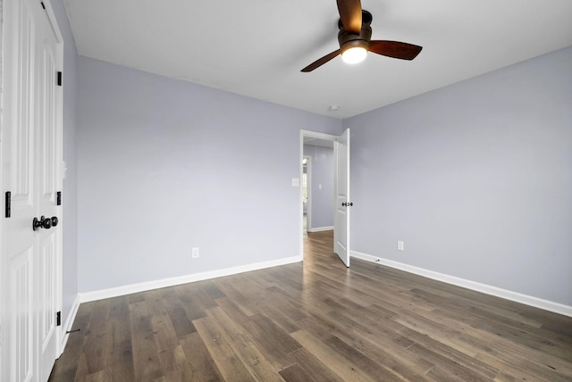 unfurnished bedroom featuring ceiling fan and dark hardwood / wood-style flooring