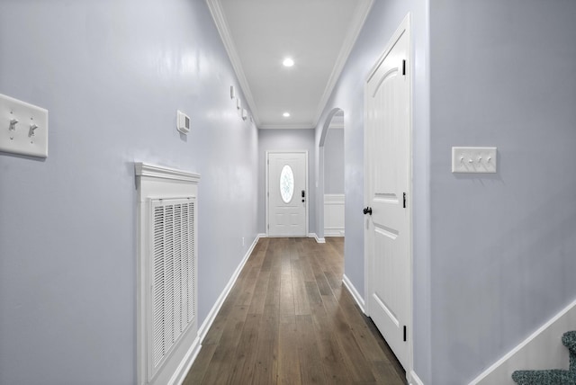 hallway with ornamental molding and dark hardwood / wood-style floors