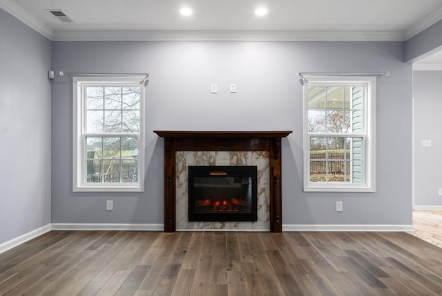 unfurnished living room with ornamental molding and dark hardwood / wood-style flooring