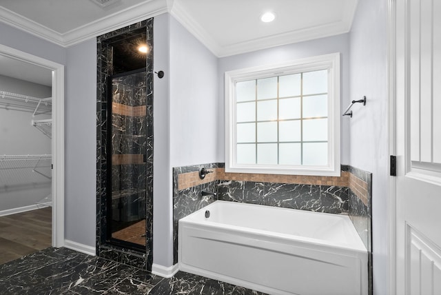 bathroom featuring ornamental molding and plus walk in shower