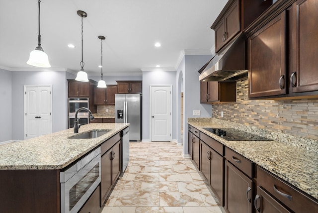 kitchen with pendant lighting, a center island with sink, light stone countertops, and appliances with stainless steel finishes