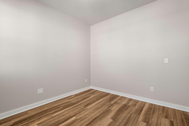 unfurnished room with wood-type flooring