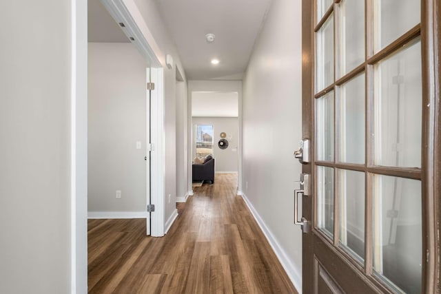 hallway with dark hardwood / wood-style floors