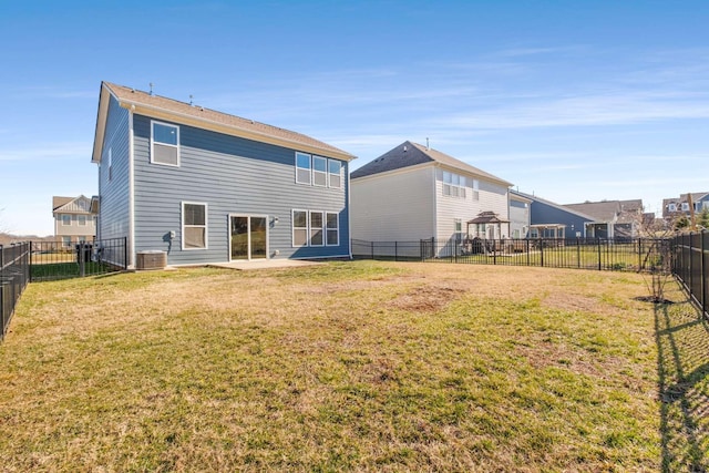 back of property featuring central AC unit and a lawn