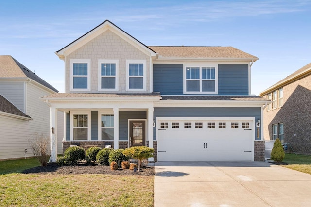 view of front facade featuring a porch, a garage, and a front yard