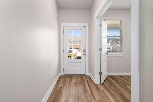 doorway to outside with plenty of natural light and light hardwood / wood-style floors