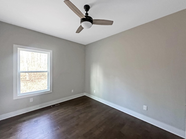 unfurnished room with dark hardwood / wood-style floors and ceiling fan