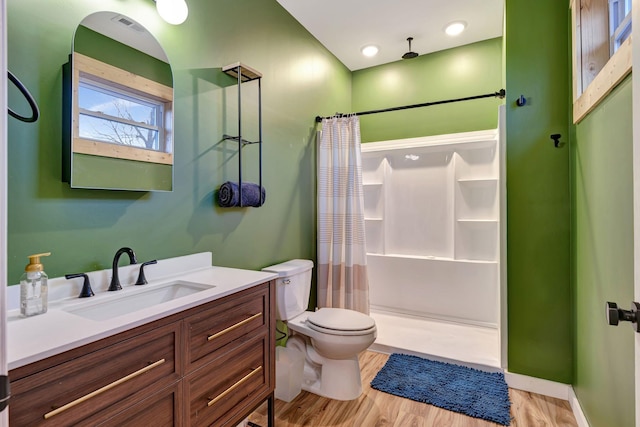 bathroom featuring vanity, toilet, hardwood / wood-style floors, and a shower with shower curtain