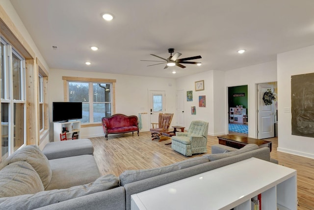 living room with ceiling fan and light hardwood / wood-style floors