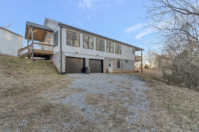 rear view of house with a garage