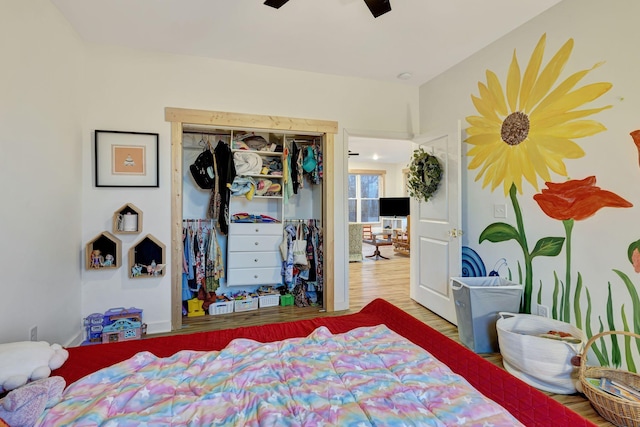 bedroom with wood-type flooring, a closet, and ceiling fan