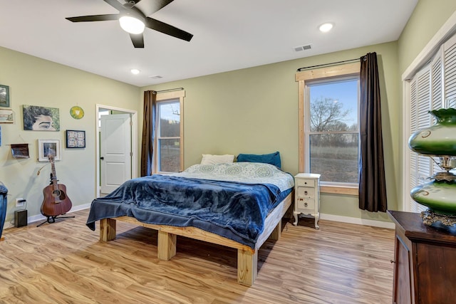 bedroom with light hardwood / wood-style floors and ceiling fan