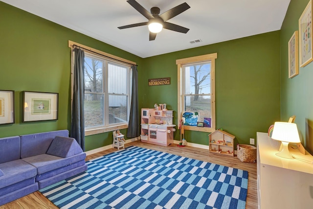 recreation room with wood-type flooring and ceiling fan