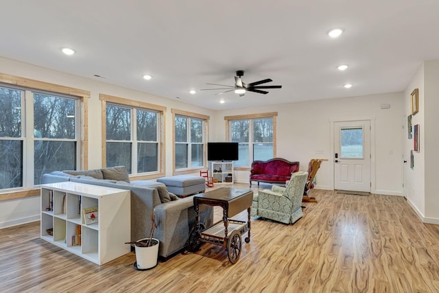 living room with light hardwood / wood-style floors and ceiling fan