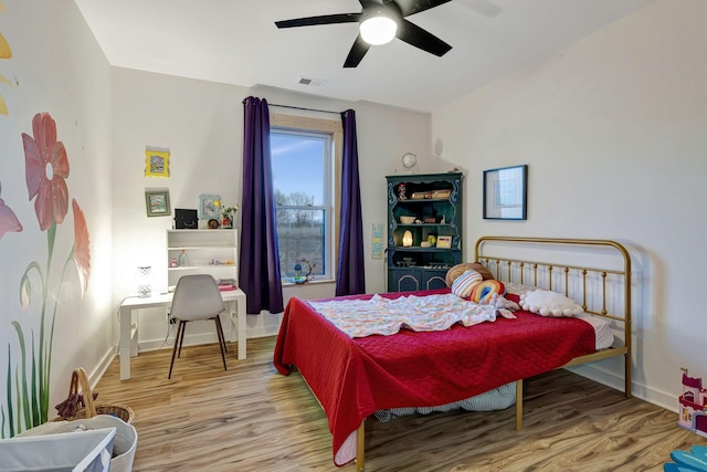 bedroom featuring hardwood / wood-style flooring and ceiling fan