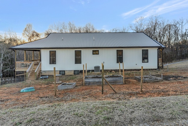 back of house featuring central air condition unit