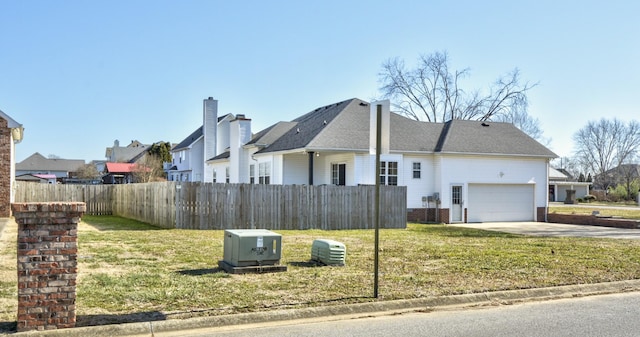 exterior space with a garage and a yard