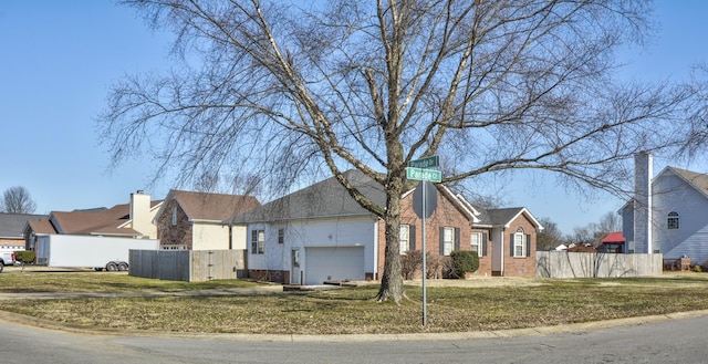 single story home with a garage and a front lawn