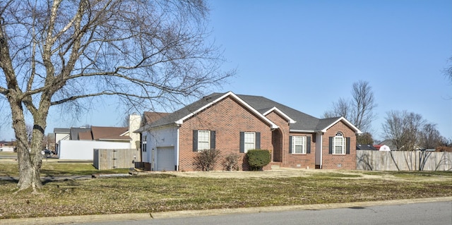 view of front of property featuring a garage and a front yard