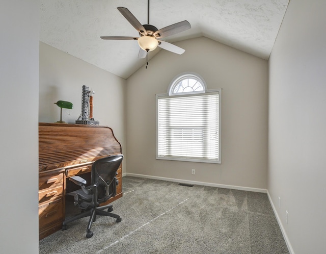 office featuring ceiling fan, vaulted ceiling, a textured ceiling, and carpet flooring