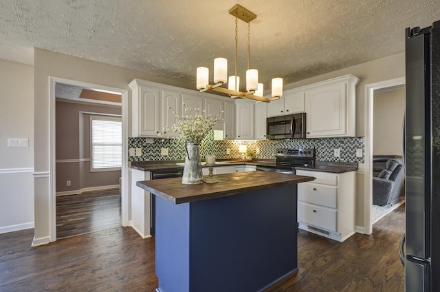 kitchen with white cabinetry, wooden counters, a kitchen island, pendant lighting, and stainless steel appliances