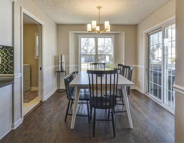 dining room featuring a chandelier, a textured ceiling, and dark hardwood / wood-style flooring