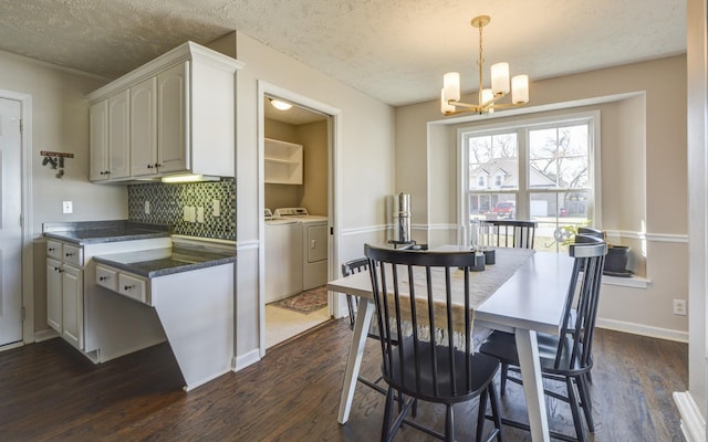 kitchen featuring pendant lighting, dark hardwood / wood-style floors, independent washer and dryer, and white cabinets