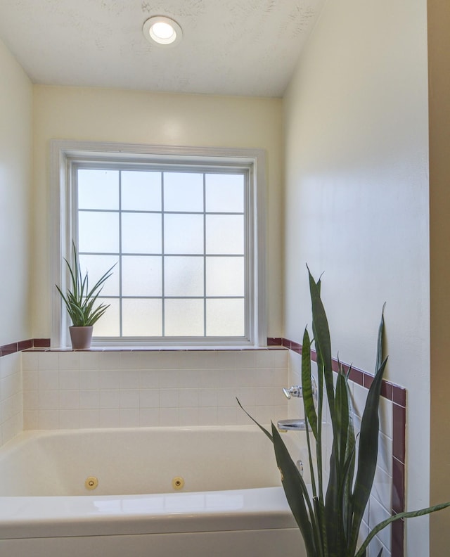 bathroom featuring a bath and a textured ceiling